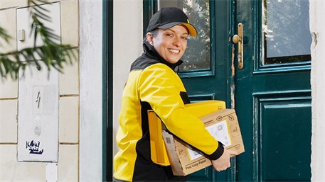 Delivery person with parcels under her arm